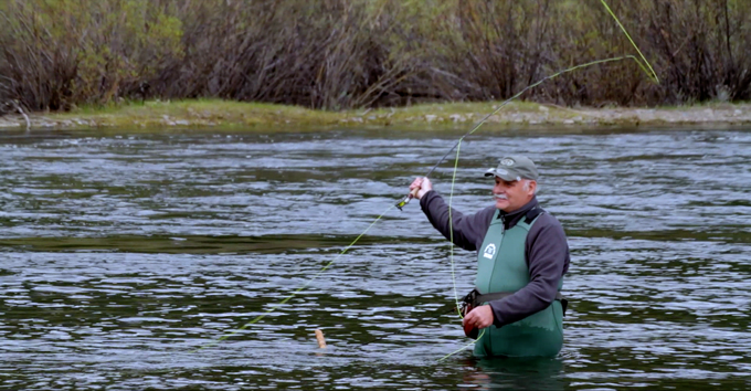 man wearing wader skins fly fishing